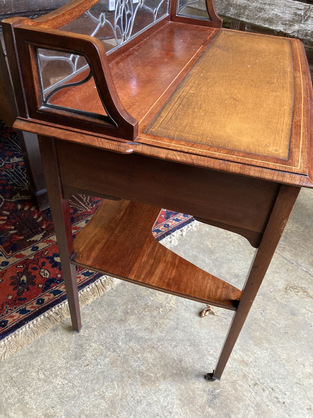 An Edwardian inlaid mahogany side table, the superstructure with an inset stained glass panel, width 95cm, depth 50cm, height 91cm